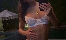 slender-brunette-posing-in-sexy-white-lingerie-outside